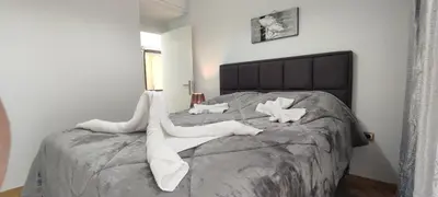 a bedroom with a bed with white socks on it at Ixian House Apartment in Ixia