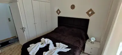 a bedroom with a bed with a black comforter at Ixian House Apartment in Ixia