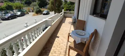 a balcony with a table and chairs and a street at Ixian House Apartment in Ixia