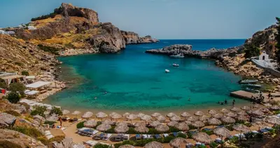 an aerial view of a beach with umbrellas at Toulipa Lindos in Líndos