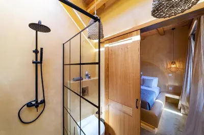 a room with a shower with a bed in it at Eftopia Villa Kolympia by Onar Villas in Kolimbia