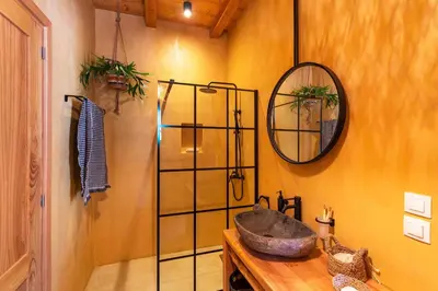 a bathroom with a sink and a mirror at Eftopia Villa Kolympia by Onar Villas in Kolimbia