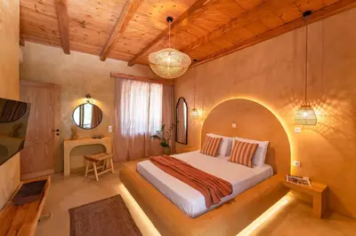 a bedroom with a large bed in a room at Eftopia Villa Kolympia by Onar Villas in Kolimbia