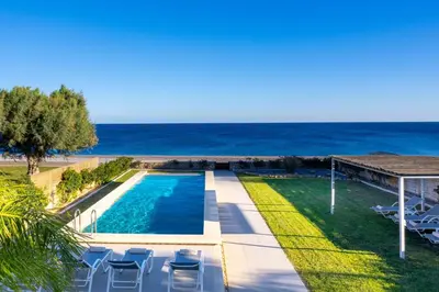 a swimming pool with the ocean in the background at Sea Homes Villas- Villa Alberto in Kiotari