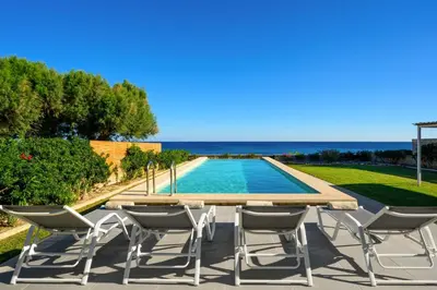 a patio with a table and chairs next to a pool at Sea Homes Villas-Villa Sylvia in Kiotari