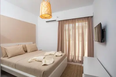 a bedroom with a bed with towels on it at Sea Homes Villas-Villa Sylvia in Kiotari