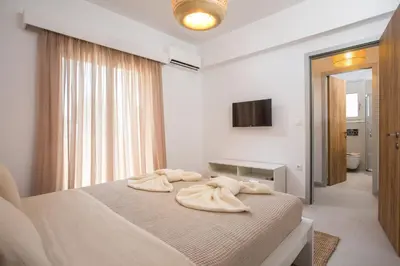 a bedroom with a bed with towels on it at Sea Homes Villas-Villa Sylvia in Kiotari