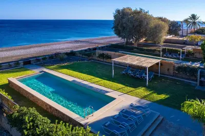 an overhead view of a swimming pool with the ocean in the background at Sea Homes Villas-Villa Sylvia in Kiotari