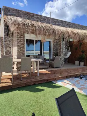 a deck with a table and chairs and a patio at Peace & View in Archangelos