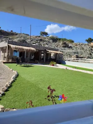 a house with a green yard with a house at Peace & View in Archangelos