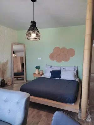 a bedroom with a bed and a pendant light at Peace & View in Archangelos