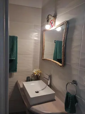 a bathroom with a white sink and a mirror at Peace & View in Archangelos