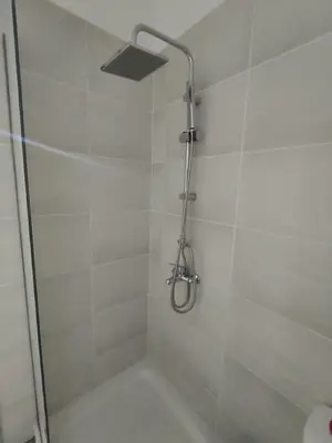 a shower with a shower head in a bathroom at Peace & View in Archangelos