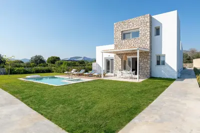 a villa with a swimming pool and a yard at Ossiano Pool Villas,Heating Pool, 2 min drive to Haraki Beach & 10 min to Lindos in Haraki