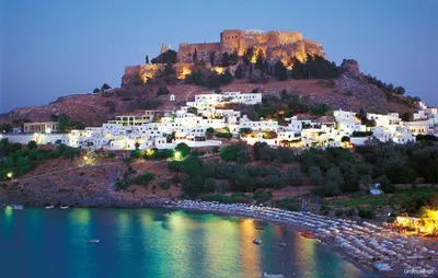 a town with a castle on top of a hill at Ossiano Pool Villas,Heating Pool, 2 min drive to Haraki Beach & 10 min to Lindos in Haraki