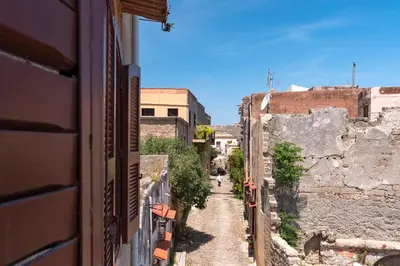 an alley way in an old city with buildings at Traditional 3 bedroom house in the Old Town in Rhodes Town