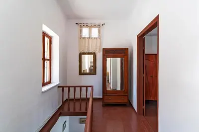 a hallway with a table and a chair and a mirror at Traditional 3 bedroom house in the Old Town in Rhodes Town