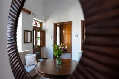 a room with a table and a vase of flowers at Traditional 3 bedroom house in the Old Town in Rhodes Town