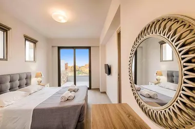 a bedroom with a large mirror and a bed at Villa Angelina Olivestone by Villa Plus in Yennadhion