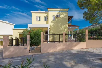 a house with a gate and a driveway at Villa Ermis Springs by Villa Plus in Kolimbia