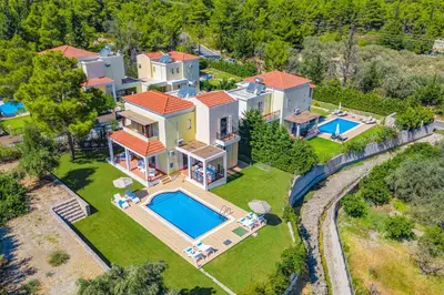an aerial view of a house with a swimming pool at Villa Ermis Springs by Villa Plus in Kolimbia