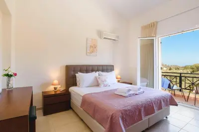 a bedroom with a bed and a balcony at Villa Ermis Springs by Villa Plus in Kolimbia