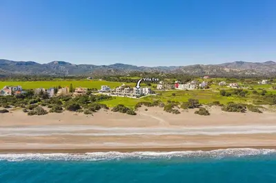 an aerial view of a resort on a beach at Villa Eva Olivestone by Villa Plus in Yennadhion