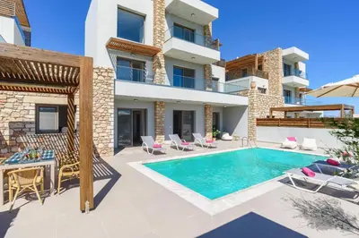 an image of a villa with a swimming pool at Villa Nikos Olivestone by Villa Plus in Yennadhion