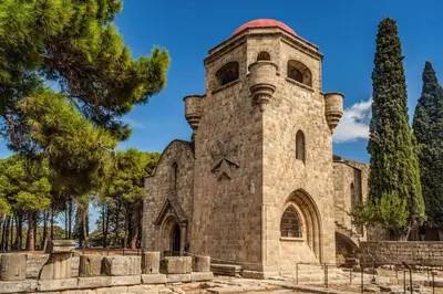 an old stone church with a red roof at Villa Paleos Aegean by Villa Plus in Ialyssos