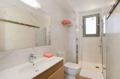 a bathroom with a sink and a toilet and a mirror at Villa Paleos Hillside by Villa Plus in Ialyssos