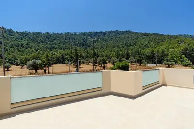a balcony with a view of the mountains at Villa Paleos Hillside by Villa Plus in Ialyssos