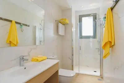 a bathroom with a shower and a sink and a toilet at Villa Paleos Sunset by Villa Plus in Ialyssos