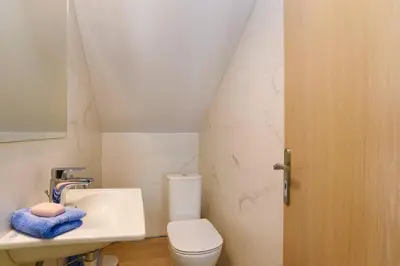 a bathroom with a white toilet and a sink at Villa Paleos Sunset by Villa Plus in Ialyssos
