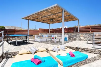 a pavilion with two beds and a ping pong table at Villa Alcyone Seastone by Villa Plus in Kiotari