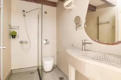 a bathroom with a shower and a sink and a toilet at Villa Alcyone Seastone by Villa Plus in Kiotari