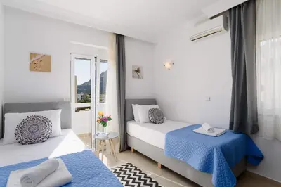 a bedroom with two beds and a window at Villa Alexia by Villa Plus in Pefki Rhodes