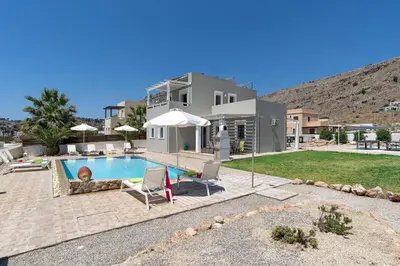 a house with a swimming pool in the yard at Villa Alexia by Villa Plus in Pefki Rhodes