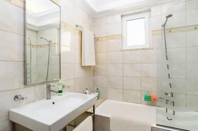 a white bathroom with a sink and a tub at Villa Alexia by Villa Plus in Pefki Rhodes