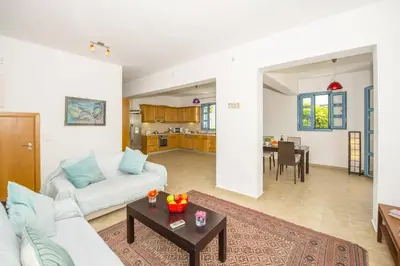 a living room with a white couch and a table at Villa Aqua Blu by Villa Plus in Líndos