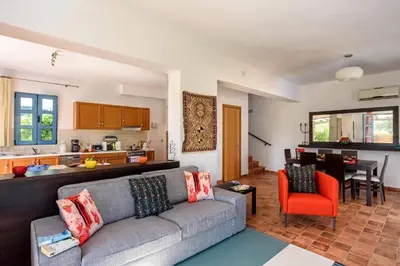 a living room with a couch and a kitchen at Villa Aqua Maris by Villa Plus in Líndos