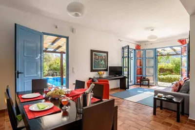 a dining room and living room with a table at Villa Aqua Maris by Villa Plus in Líndos