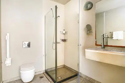 a bathroom with a shower and a toilet and a sink at Villa Beatris Seastone by Villa Plus in Kiotari
