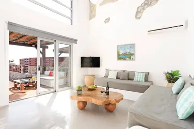 a living room with a couch and a coffee table at Villa Beatris Seastone by Villa Plus in Kiotari