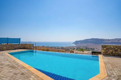 a swimming pool with a view of the ocean at Villa Castello by Villa Plus in Líndos