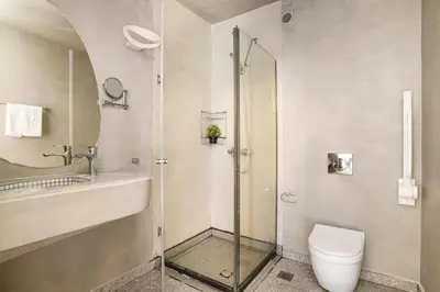 a bathroom with a shower and a toilet and a sink at Villa Chloe Seastone by Villa Plus in Kiotari