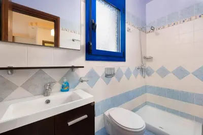 a bathroom with a sink and a toilet and a tub at Villa Christina Rhodes by Villa Plus in Líndos