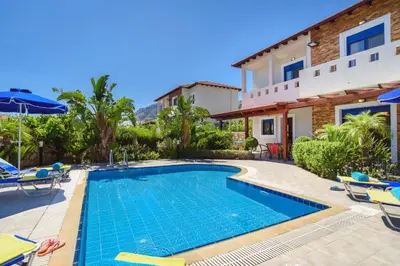 a swimming pool in front of a house at Villa Christina Rhodes by Villa Plus in Líndos