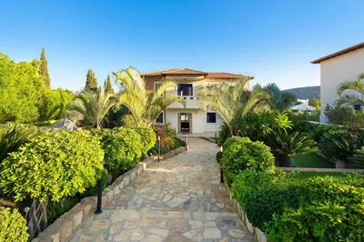 a house with a walkway in front of a yard at Villa Clive by Villa Plus in Líndos