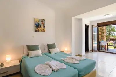 a bedroom with two beds with towels on them at Villa Despina by Villa Plus in Pefki Rhodes