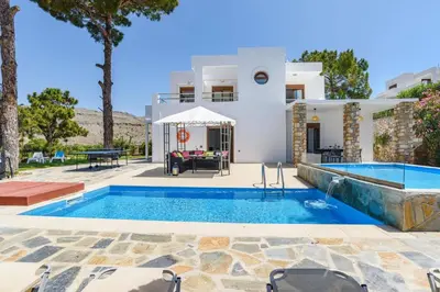 a villa with a swimming pool and a house at Villa Despina by Villa Plus in Pefki Rhodes